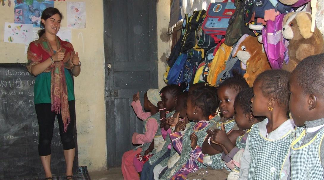 A volunteer speaks to children at a care centre in Senegal A volunteer works with children in senegal on a project made for teenagers